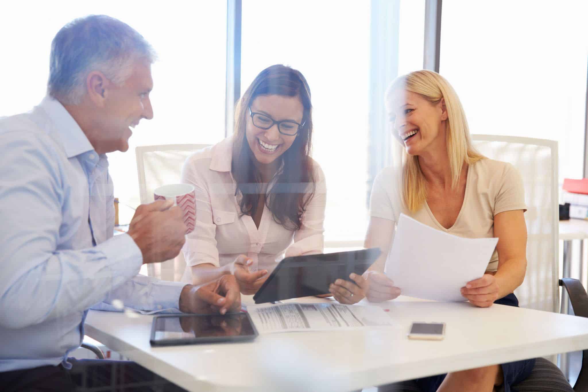 Group of colleagues meeting around a table in an office