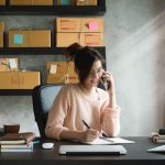 woman at desk talking on phone