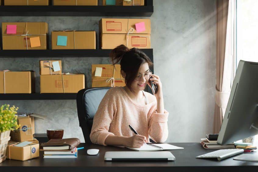 woman at desk talking on phone