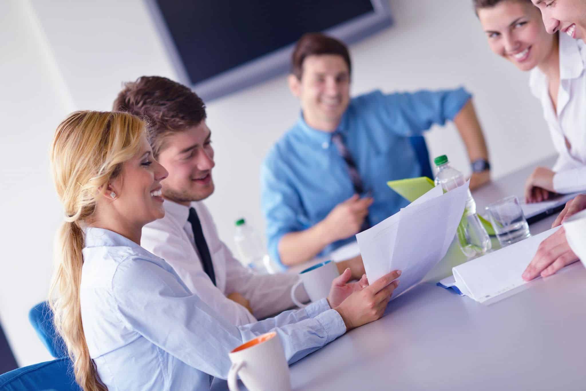 business woman showing papers to colleagues