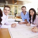 happy employees around a table at work