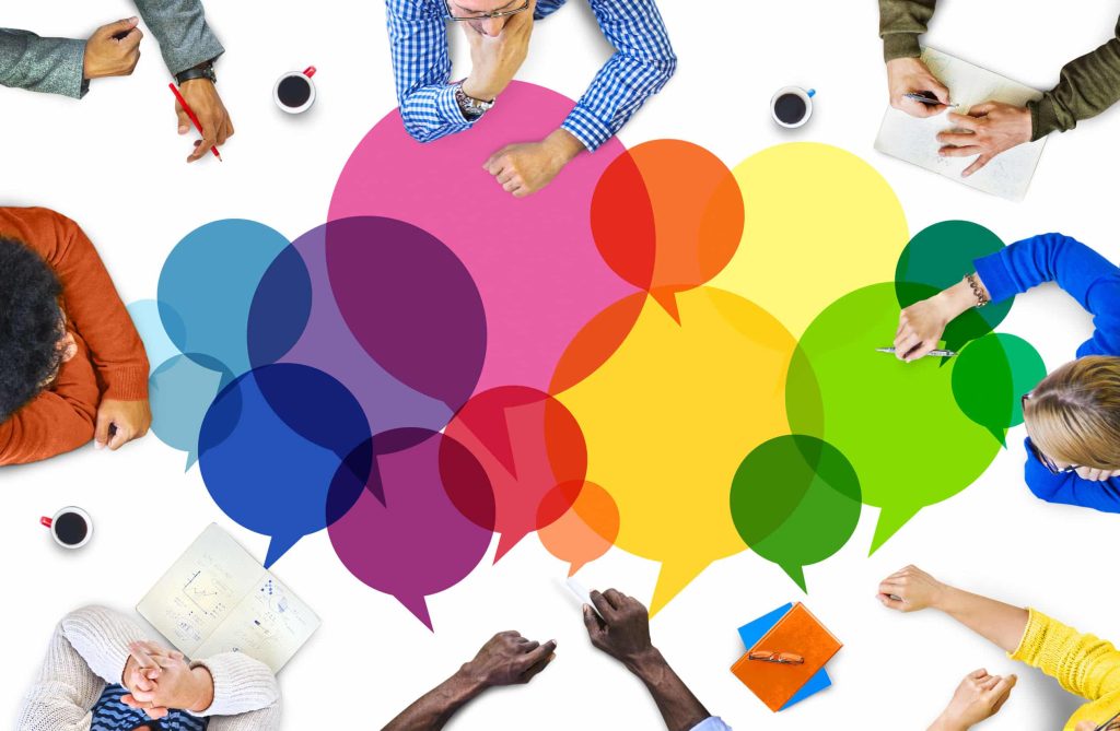 marketing team gathered around a table with colorful speech bubbles