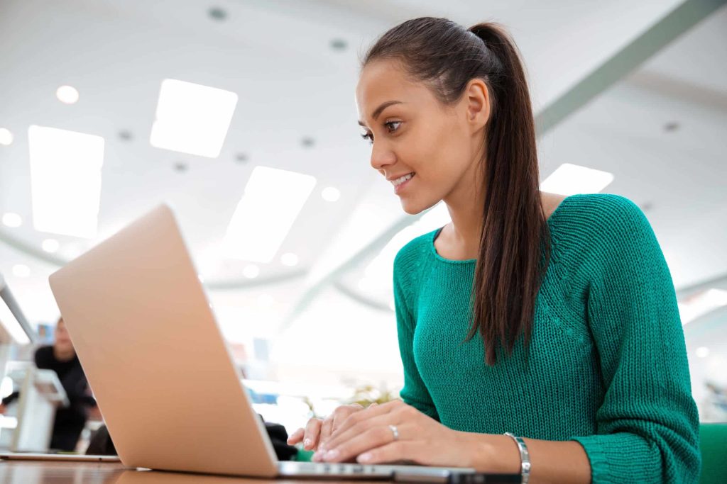 woman on her laptop at the office, reading a non-pushy sales email
