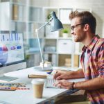 a designer at his computer analyzing the body of his website