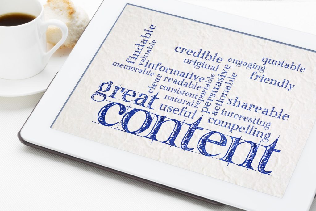 a content marketing word cloud on a table next to a cup of coffee and pastry