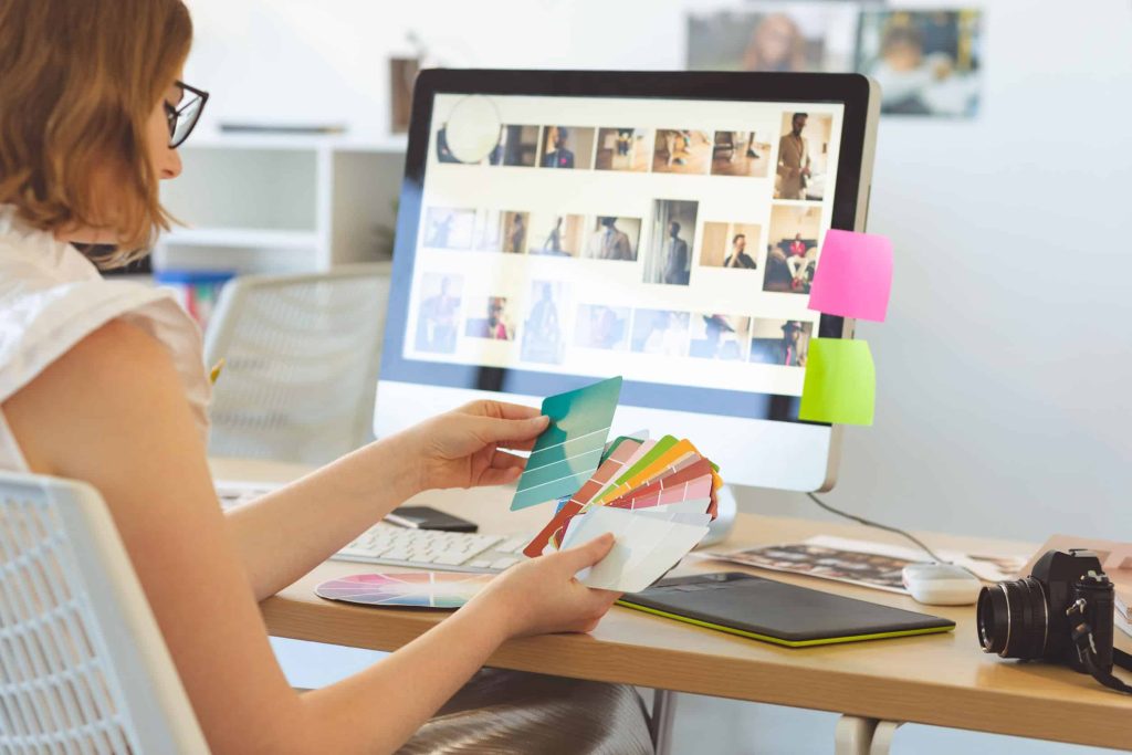 a web designer choosing photos and color swatches for her site