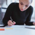 a businesswoman writing content and taking notes