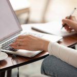a woman working on web copy and taking notes