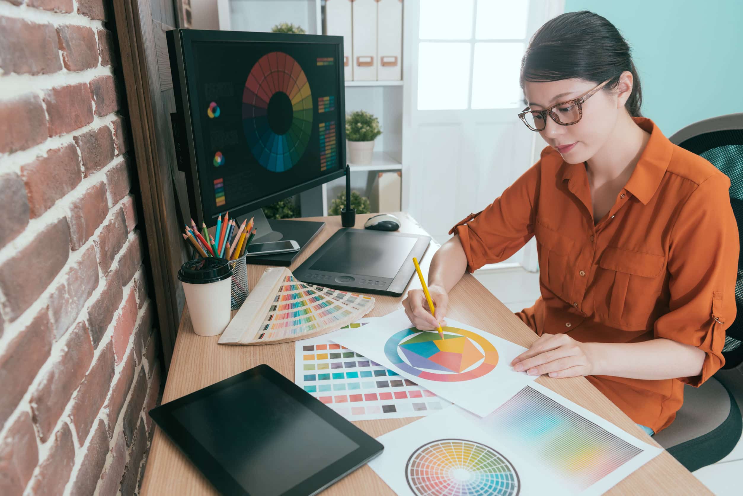 a graphic designer working on her brand’s color palette
