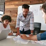 a group of business colleagues going over email analytics