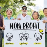 five nonprofit volunteers holding a sign in a park