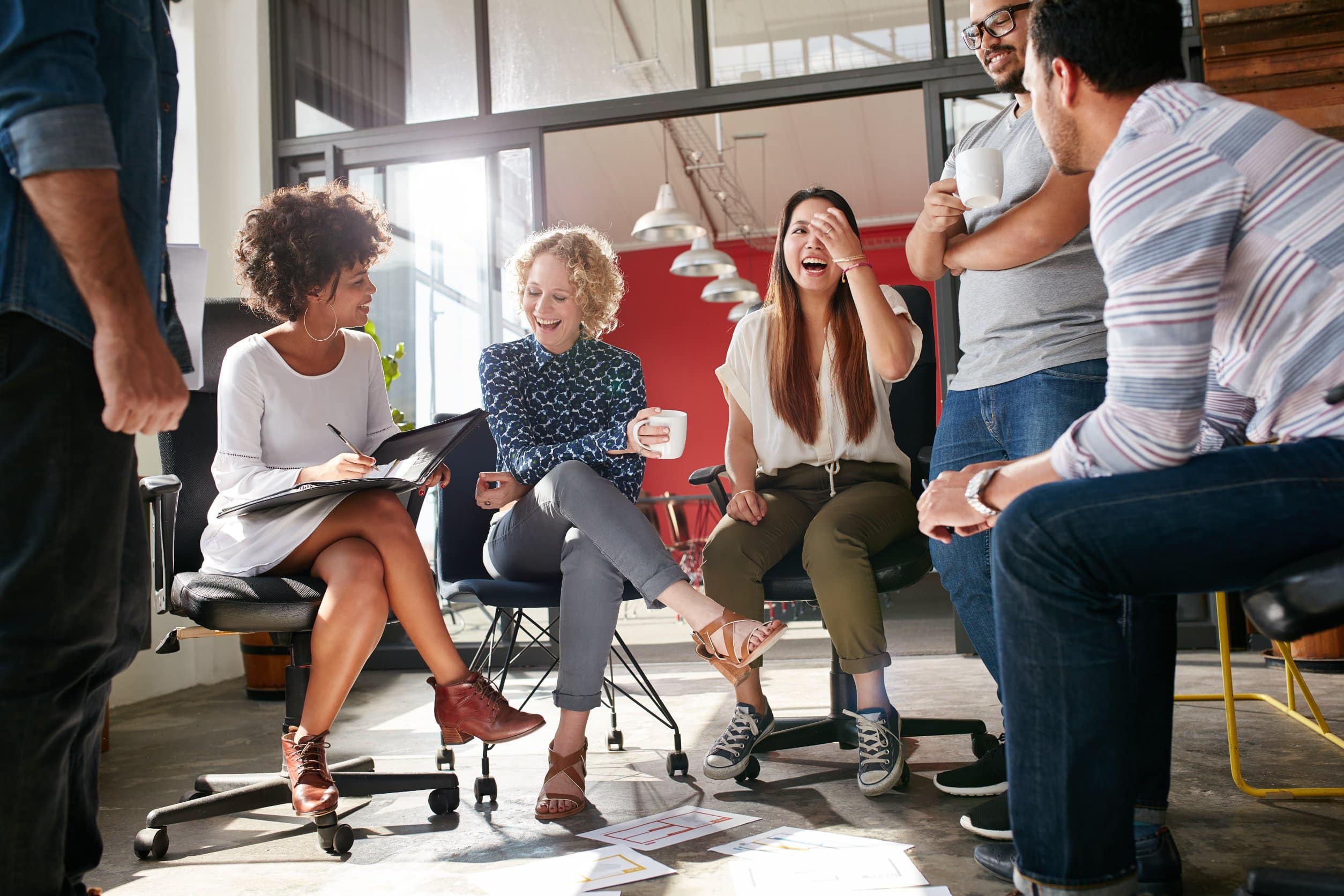 A group of coworkers laughing at meeting