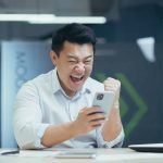 Happy man looking at his phone