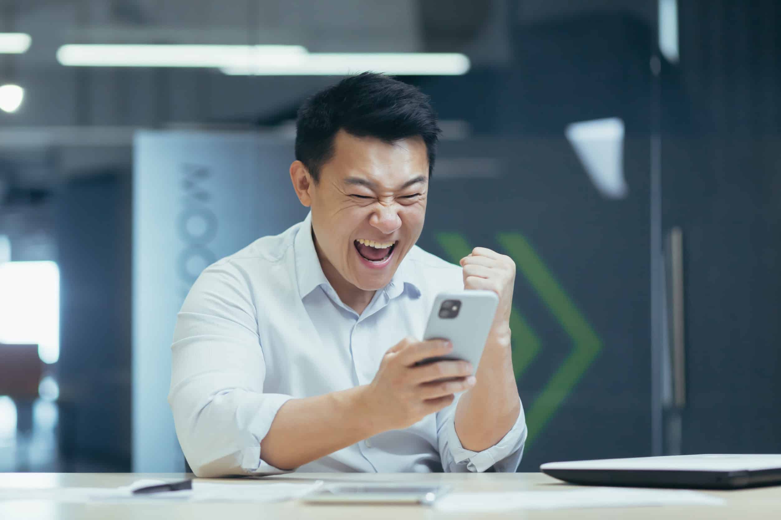 Happy man looking at his phone