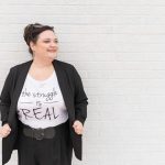 Crista Tharp leaning against a wall