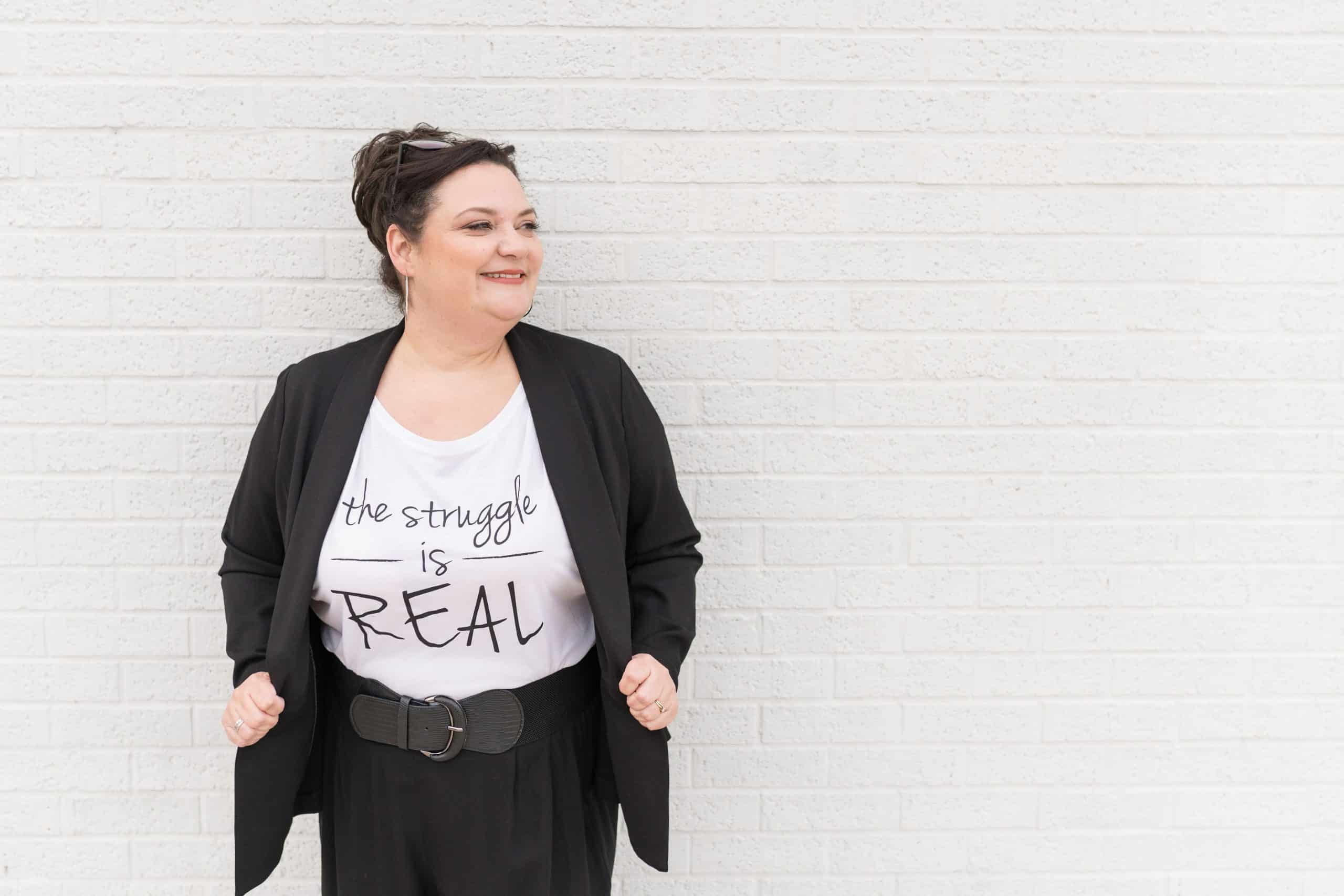 Crista Tharp leaning against a wall