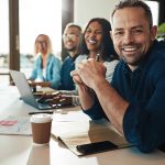 a marketing team sitting at a conference table reviewing their internet marketing strategy