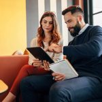 business man and woman looking at a tablet reviewing a marketing sales funnel