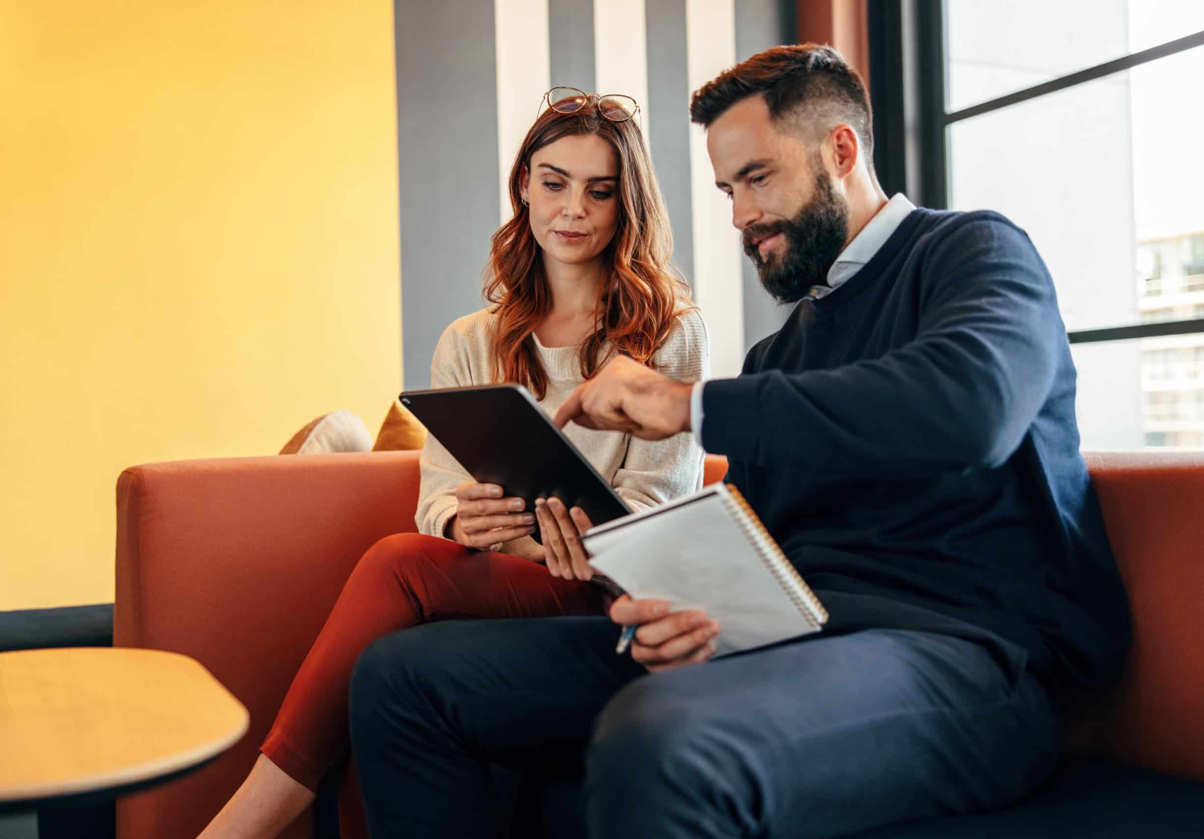 business man and woman looking at a tablet reviewing a marketing sales funnel