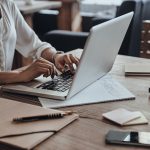Woman working on email opt-ins on laptop